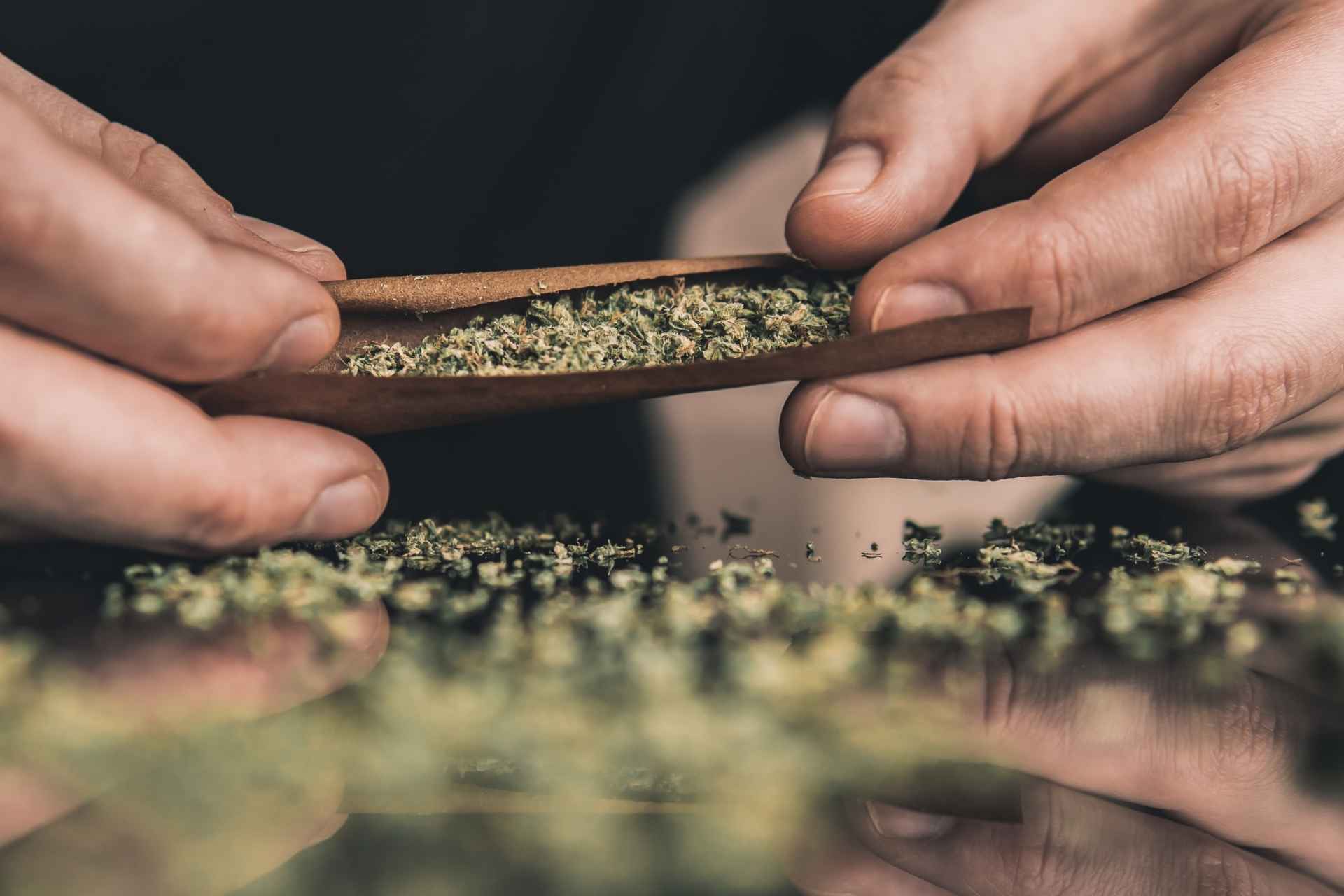 Hands rolling a marijuana joint for marijuana addiction treatment page