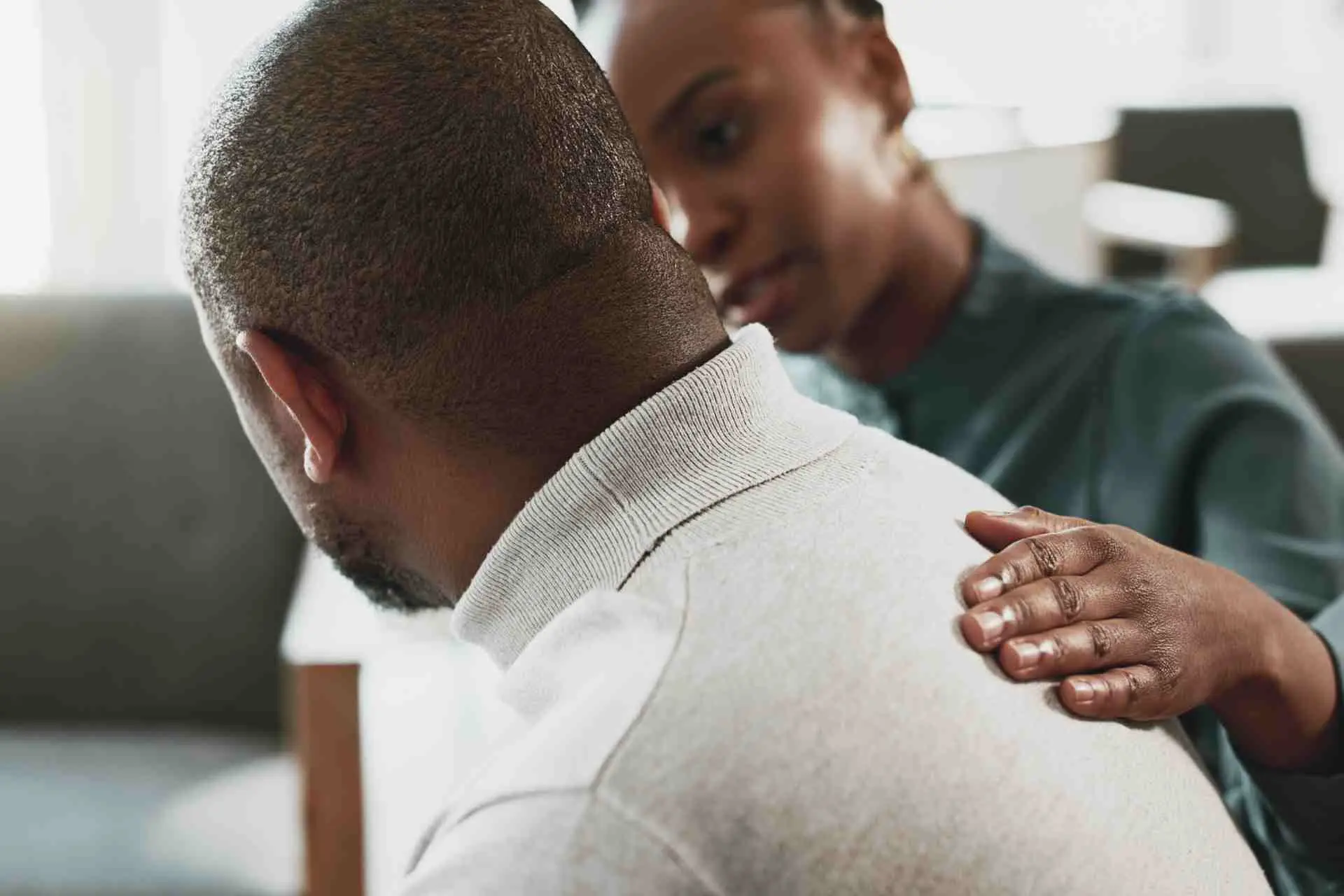 Therapist offering emotional support during opioid addiction treatment session